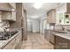 An updated kitchen features stainless steel appliances, granite countertops, and tiled flooring for a clean and functional design at 100 Brookstone Dr, Mount Holly, NC 28120