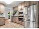 This modern kitchen is equipped with stainless steel appliances and features granite countertops for a sleek cooking space at 100 Brookstone Dr, Mount Holly, NC 28120