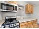 Kitchen area showcasing granite countertops, wooden cabinets, and stainless-steel appliances at 100 Brookstone Dr, Mount Holly, NC 28120