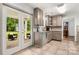 This kitchen offers a view of an outdoor space with seating, blending indoor and outdoor living seamlessly through patio doors at 100 Brookstone Dr, Mount Holly, NC 28120