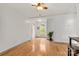 Bright living room featuring hardwood floors, a ceiling fan, and a view of the front door and window at 100 Brookstone Dr, Mount Holly, NC 28120