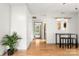 Open-concept living area with hardwood floors, a dining table, and views into other rooms at 100 Brookstone Dr, Mount Holly, NC 28120