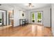 A spacious living area boasts hardwood floors, a bar-style counter, and patio access, ideal for entertaining and relaxation at 100 Brookstone Dr, Mount Holly, NC 28120