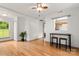 Open living area with hardwood floors, natural light from a large window, and a casual dining nook for relaxed living at 100 Brookstone Dr, Mount Holly, NC 28120
