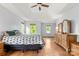 Spacious main bedroom with hardwood floors, natural light, and a tray ceiling at 100 Brookstone Dr, Mount Holly, NC 28120