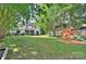 Spacious backyard with a swing set and a serene outdoor setting at 10016 Tealridge Ln, Charlotte, NC 28277