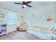 Bedroom featuring a bed, ceiling fan, and colorful decor, creating a cozy and inviting space at 10016 Tealridge Ln, Charlotte, NC 28277