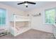 Bedroom featuring a bunk bed, ceiling fan, and playful decor, perfect for children at 10016 Tealridge Ln, Charlotte, NC 28277