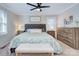 Bedroom featuring a tufted headboard, ceiling fan, and neutral tones, creating a serene and inviting space at 10016 Tealridge Ln, Charlotte, NC 28277