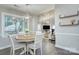 Sunlit dining room features an elegant chandelier and wood-look floors at 10016 Tealridge Ln, Charlotte, NC 28277