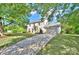 Charming two-story traditional home boasts a two-car garage and a long driveway in a lush, green setting at 10016 Tealridge Ln, Charlotte, NC 28277