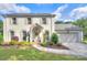Charming two-story painted brick home with a manicured lawn, lush landscaping, and a welcoming front entrance at 10016 Tealridge Ln, Charlotte, NC 28277