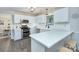 Modern kitchen with white cabinets, stainless steel appliances, quartz countertops, and subway tile backsplash at 10016 Tealridge Ln, Charlotte, NC 28277