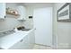 Functional laundry room with modern washer and dryer units at 10016 Tealridge Ln, Charlotte, NC 28277