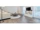 Bright living room with hardwood floors, plush sofa and playroom at 10016 Tealridge Ln, Charlotte, NC 28277