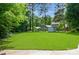 Spacious backyard with shed and privacy fencing, surrounded by lush greenery at 104 Gallarie Pl, Salisbury, NC 28144