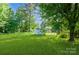 Large backyard with mature trees, well-maintained lawn, shed, and classic wooden fence at 104 Gallarie Pl, Salisbury, NC 28144