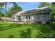 Expansive backyard features a brick patio, lush lawn, and mature trees at 104 Gallarie Pl, Salisbury, NC 28144