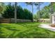 Large backyard featuring a well-maintained lawn, classic wooden fence, and mature trees at 104 Gallarie Pl, Salisbury, NC 28144