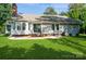Back of house with well maintained lawn, patio, and mature trees at 104 Gallarie Pl, Salisbury, NC 28144