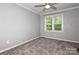 This cozy bedroom has neutral walls, carpet flooring, and a ceiling fan to help keep it cool at 104 Gallarie Pl, Salisbury, NC 28144