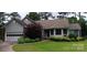 Charming single-story home featuring well-maintained landscaping and attached two-car garage at 104 Gallarie Pl, Salisbury, NC 28144