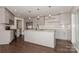 Open concept kitchen boasts stainless steel appliances, granite counters, and a large island at 104 Gallarie Pl, Salisbury, NC 28144