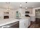Open kitchen with island features granite counters and connects to a Gathering room with a fireplace at 104 Gallarie Pl, Salisbury, NC 28144