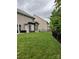 Private backyard with a well-maintained lawn, a fence, and a pergola-covered patio at 10817 Bere Island Dr, Charlotte, NC 28278
