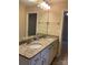 Bathroom features double sinks, granite countertops, and a large mirror with vanity lights at 10817 Bere Island Dr, Charlotte, NC 28278