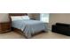 Bedroom features a bed, dresser, and two nightstands, brightened by a window at 10817 Bere Island Dr, Charlotte, NC 28278
