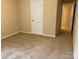 Bedroom with neutral carpet, a large door, and light-colored walls, and a large closet at 10817 Bere Island Dr, Charlotte, NC 28278