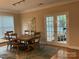 Elegant dining room with a large table, seating for six, and a decorative rug at 10817 Bere Island Dr, Charlotte, NC 28278