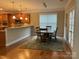 Bright dining area features an open floor plan, hardwood floors, and adjacent kitchen access at 10817 Bere Island Dr, Charlotte, NC 28278