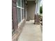 Covered front porch with stone pillars and space for seating offers a welcoming entry to the home at 10817 Bere Island Dr, Charlotte, NC 28278