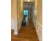 Inviting hallway featuring hardwood floors and detailed molding, leading to other areas of the home at 10817 Bere Island Dr, Charlotte, NC 28278