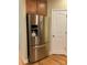 Stainless steel French door refrigerator is next to a pantry or storage closet at 10817 Bere Island Dr, Charlotte, NC 28278