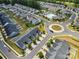 Overhead view of a neighborhood with townhomes, roundabout, pool, and pond at 1108 Stella Ct, Monroe, NC 28110