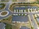 Aerial shot of townhomes with street view of garages in a neighborhood with roundabout at 1108 Stella Ct, Monroe, NC 28110