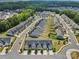 Aerial view of a residential neighborhood with sidewalks, ponds, and lots of trees at 1108 Stella Ct, Monroe, NC 28110