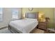 Comfortable bedroom with a gray headboard, plush carpet, and neutral wall color at 1108 Stella Ct, Monroe, NC 28110