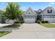 Charming townhome featuring a two-car garage, manicured lawn and tree offering curb appeal at 1108 Stella Ct, Monroe, NC 28110