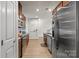 Kitchen features stainless appliances and granite countertops with a view to the living room at 1108 Stella Ct, Monroe, NC 28110