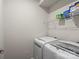Functional laundry area with modern appliances, overhead shelving, and clean neutral walls at 1108 Stella Ct, Monroe, NC 28110