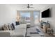 Bright living room featuring a comfortable sectional sofa, large windows, and modern furnishings at 1108 Stella Ct, Monroe, NC 28110