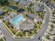 Aerial view of community pool, clubhouse, and amenities with parking and pond in the neighborhood at 1108 Stella Ct, Monroe, NC 28110