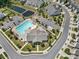 Aerial view of community pool, clubhouse, and amenities with parking and pond in the neighborhood at 1108 Stella Ct, Monroe, NC 28110