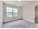 This is a bright bedroom that offers plush carpeting and a large window overlooking the neighborhood at 126 Dorian Pl, Troutman, NC 28166
