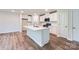 Modern kitchen with a large island, stainless steel appliances, and sleek white cabinetry at 126 Dorian Pl, Troutman, NC 28166