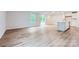 Open-concept living area with expansive windows and sliding glass doors, featuring elegant wood flooring at 126 Dorian Pl, Troutman, NC 28166